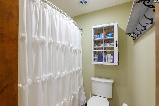 bathroom with toilet and walk in shower