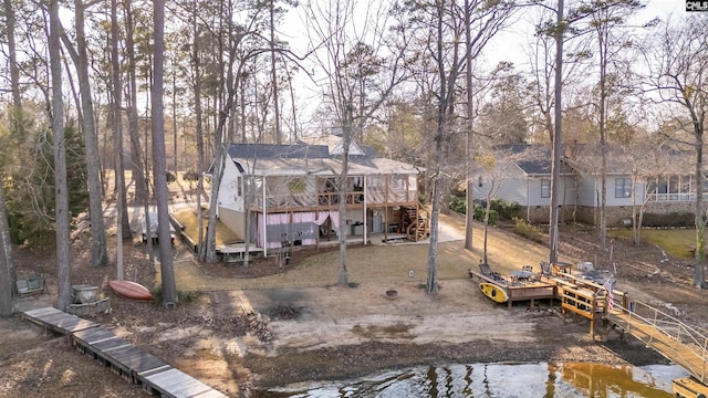 back of property featuring a deck with water view