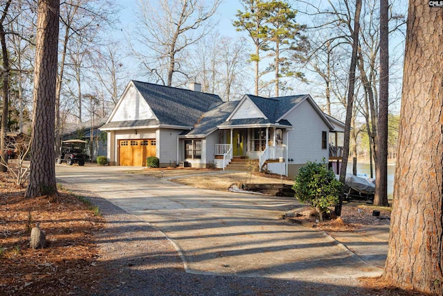 view of front of home featuring a porch and a garage