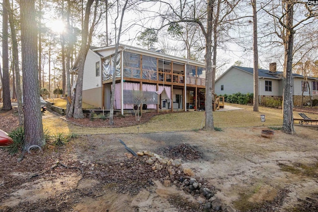 rear view of house featuring a sunroom