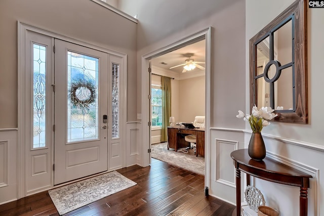 entrance foyer featuring ornamental molding and dark hardwood / wood-style floors