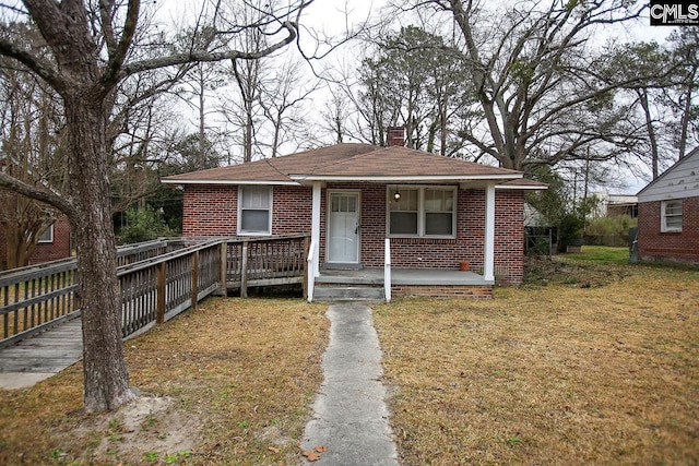 bungalow-style house with a front yard and a porch