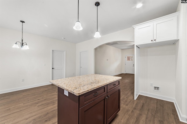 kitchen with hanging light fixtures, white cabinetry, and dark wood-type flooring