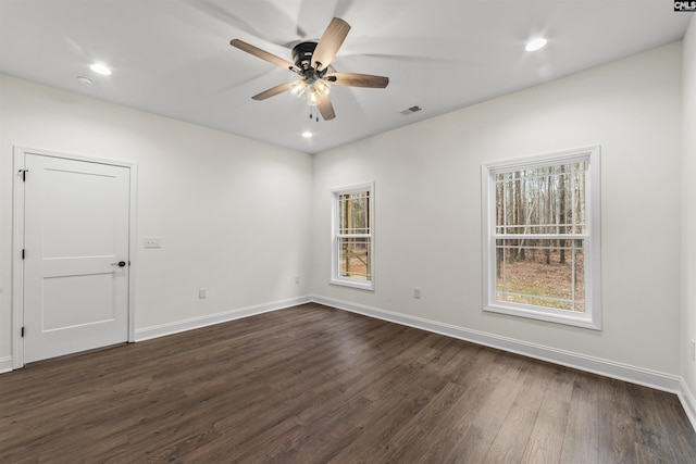 unfurnished room with ceiling fan and dark hardwood / wood-style flooring