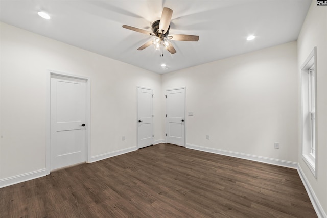 unfurnished room with dark wood-type flooring and ceiling fan