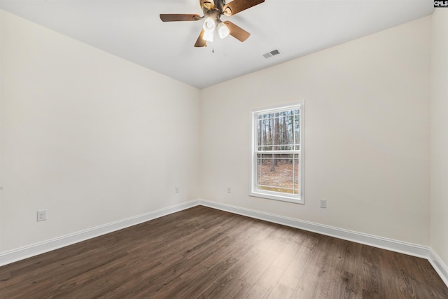 spare room featuring dark hardwood / wood-style flooring and ceiling fan