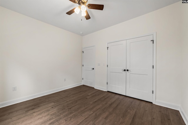 unfurnished bedroom with ceiling fan, dark hardwood / wood-style floors, and a closet