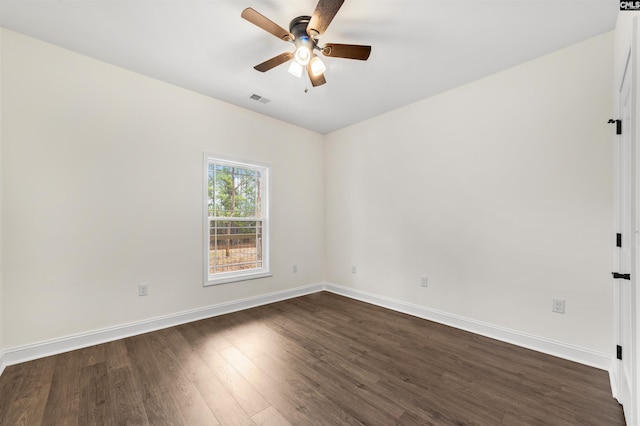 unfurnished room featuring dark wood-type flooring and ceiling fan