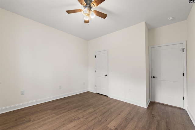 unfurnished bedroom featuring ceiling fan and dark hardwood / wood-style flooring