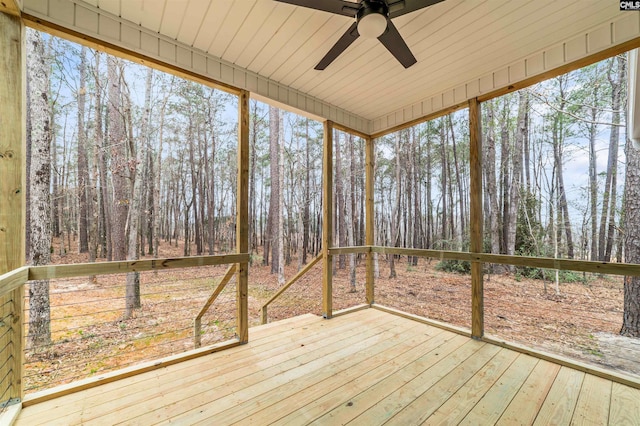 unfurnished sunroom with ceiling fan