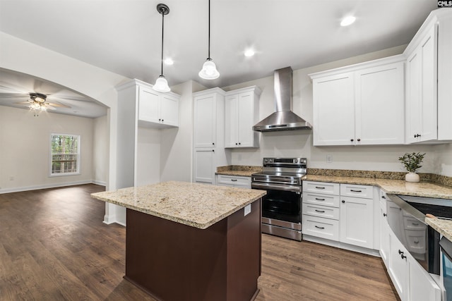 kitchen featuring white cabinetry, a center island, stainless steel range with electric cooktop, and wall chimney range hood