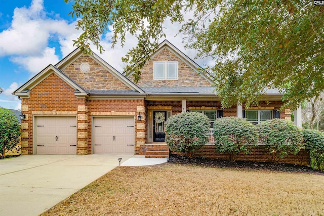 craftsman inspired home featuring driveway, brick siding, an attached garage, and a front yard