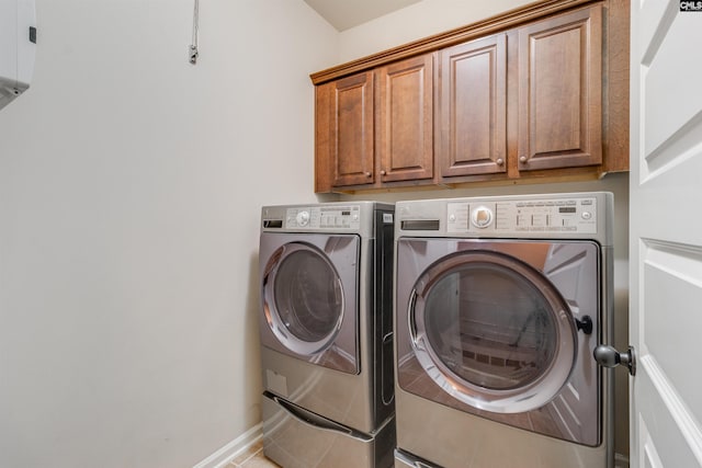 laundry area featuring cabinets, tile patterned flooring, and independent washer and dryer