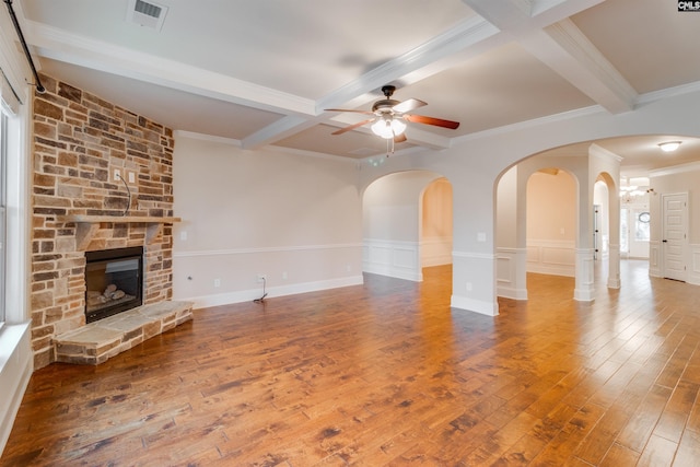 unfurnished living room featuring coffered ceiling, beam ceiling, hardwood / wood-style flooring, ceiling fan, and a fireplace