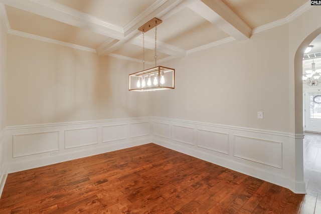 unfurnished dining area with beamed ceiling, coffered ceiling, hardwood / wood-style flooring, and ornamental molding