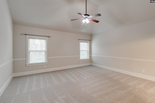 empty room featuring ceiling fan, light colored carpet, and lofted ceiling