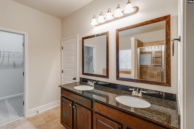 bathroom with tile patterned flooring, vanity, and a shower with shower door