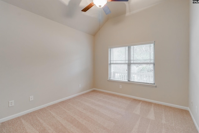 spare room with lofted ceiling, light colored carpet, and ceiling fan