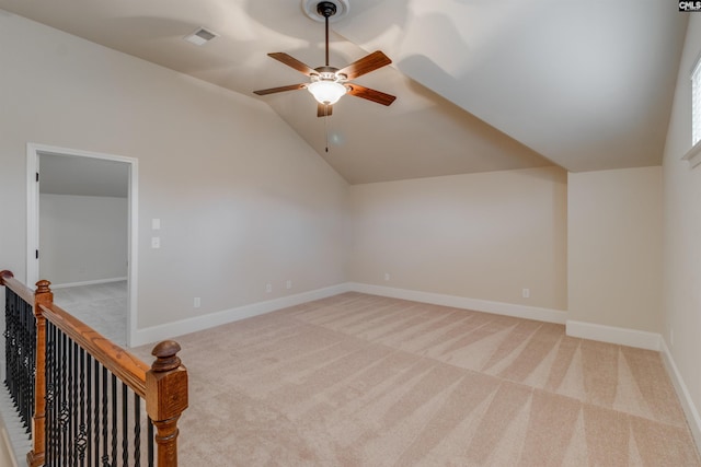 bonus room with vaulted ceiling, light colored carpet, and ceiling fan