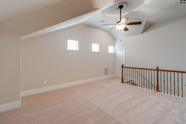 additional living space featuring lofted ceiling, light colored carpet, and ceiling fan