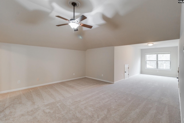 interior space featuring vaulted ceiling, light colored carpet, and ceiling fan