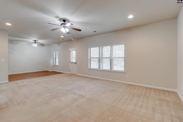 carpeted empty room featuring a wealth of natural light and ceiling fan