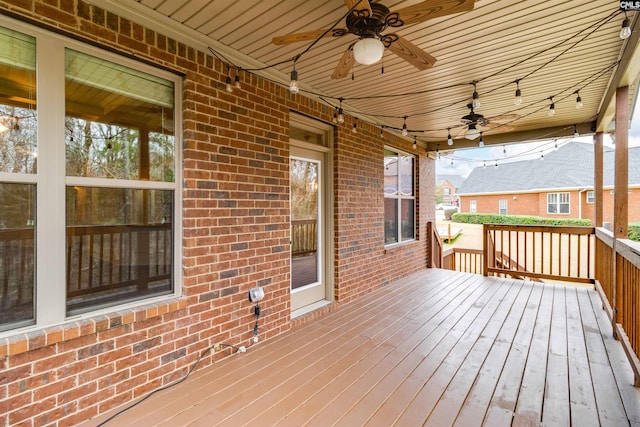 wooden deck featuring ceiling fan