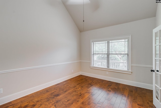 unfurnished room with lofted ceiling and dark wood-type flooring