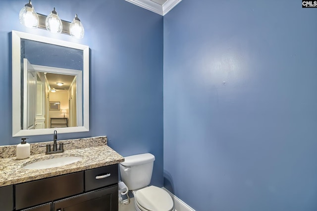 bathroom featuring vanity, crown molding, and toilet