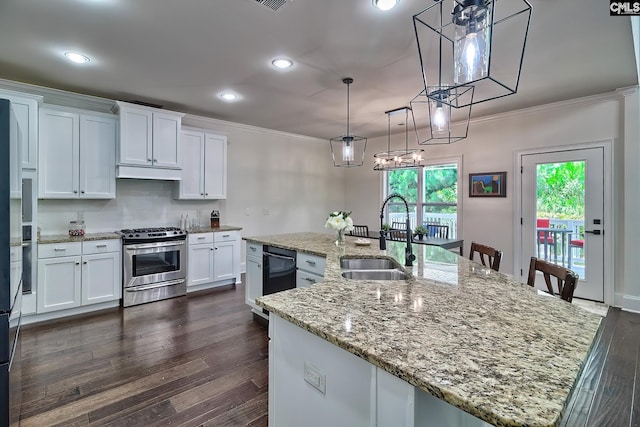 kitchen featuring sink, stainless steel gas stove, white cabinetry, light stone counters, and a kitchen island with sink