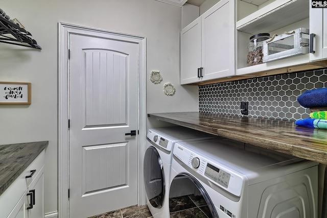 washroom featuring cabinets and washing machine and clothes dryer