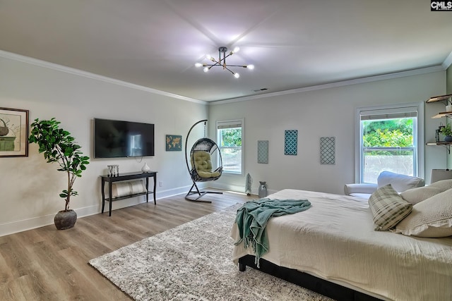 bedroom featuring crown molding, a notable chandelier, and light hardwood / wood-style flooring