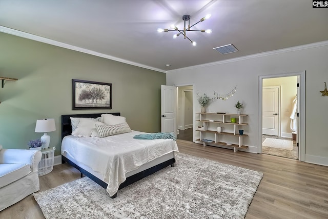 bedroom featuring ornamental molding, wood-type flooring, and a notable chandelier