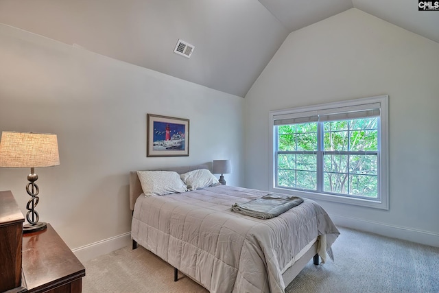 bedroom featuring vaulted ceiling and light colored carpet