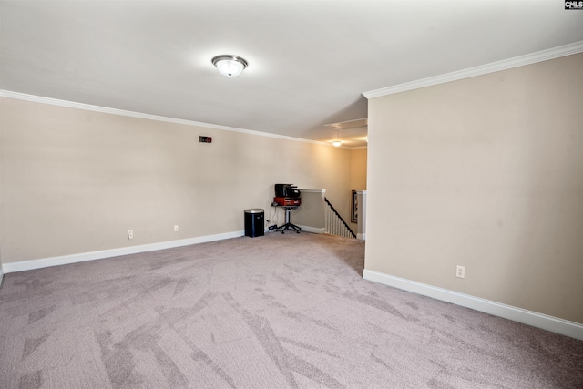 empty room featuring crown molding and light colored carpet