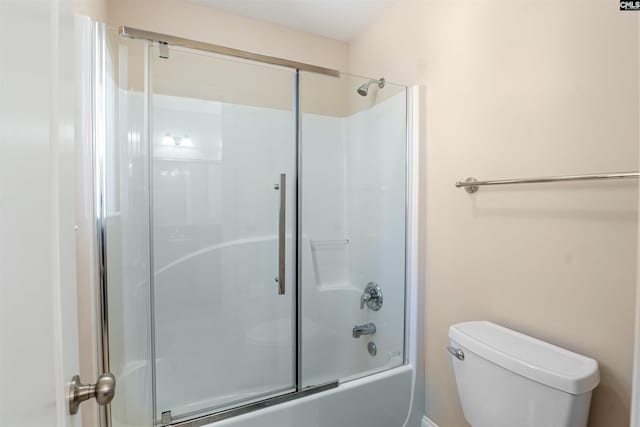 bathroom with enclosed tub / shower combo and toilet