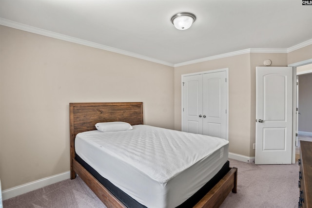 carpeted bedroom featuring ornamental molding and a closet