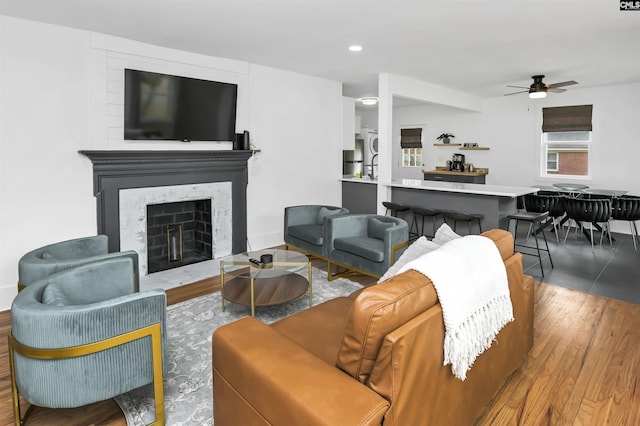 living room with hardwood / wood-style flooring and ceiling fan