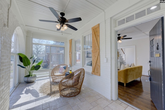 sunroom with ceiling fan