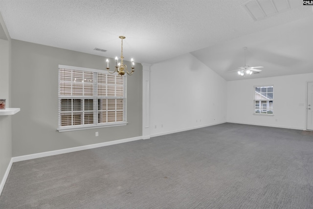 interior space with lofted ceiling, ceiling fan with notable chandelier, and a textured ceiling