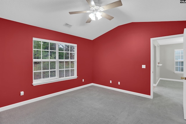 unfurnished room featuring lofted ceiling, carpet floors, and ceiling fan