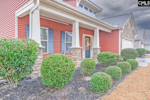 view of exterior entry with covered porch