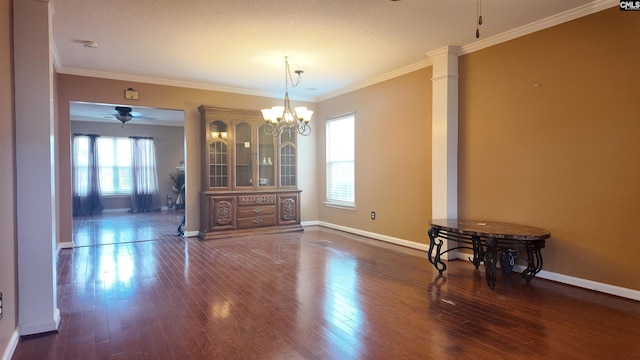 dining space with crown molding, dark hardwood / wood-style floors, ceiling fan with notable chandelier, and ornate columns