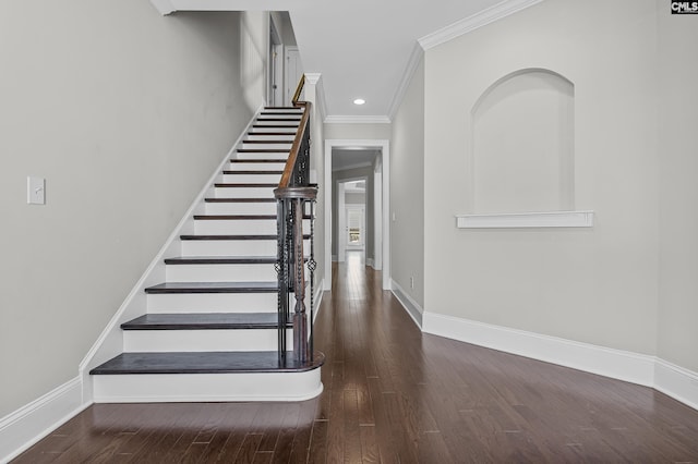 stairs featuring hardwood / wood-style flooring and crown molding