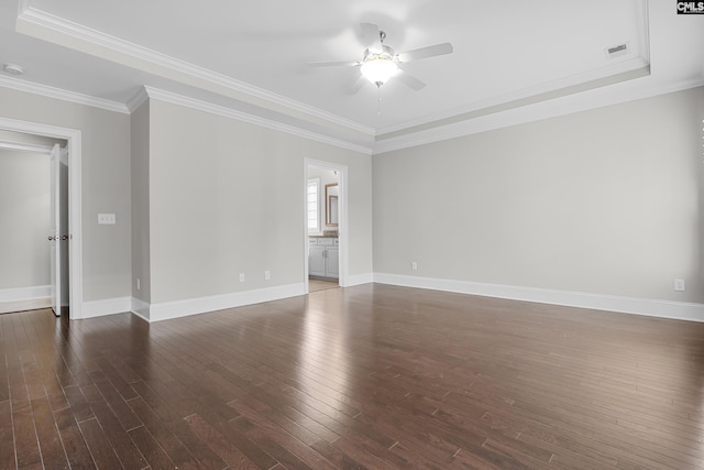 empty room featuring dark wood-type flooring, ceiling fan, and ornamental molding