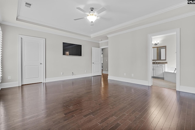 interior space featuring ceiling fan, ornamental molding, dark hardwood / wood-style flooring, and a tray ceiling