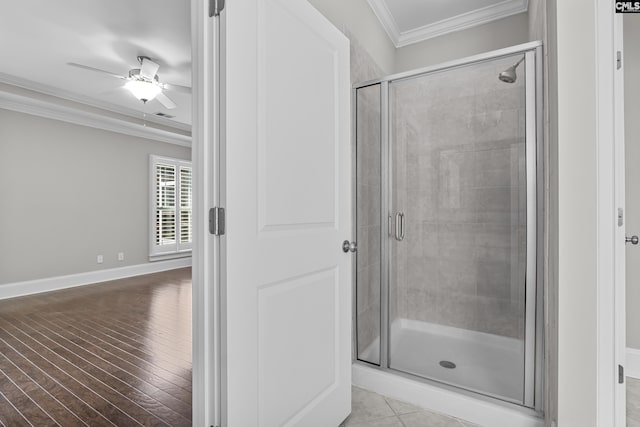 bathroom featuring an enclosed shower, hardwood / wood-style floors, ornamental molding, and ceiling fan