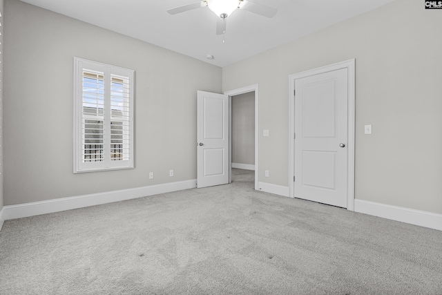 unfurnished bedroom featuring ceiling fan and light carpet