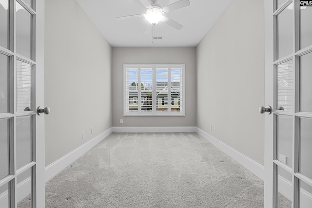 carpeted spare room featuring ceiling fan