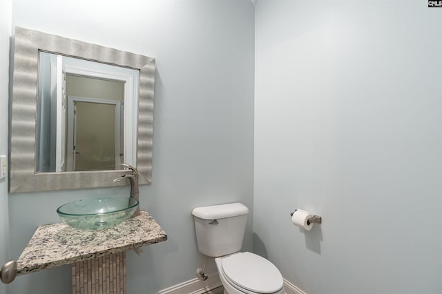 bathroom with radiator heating unit, toilet, and sink